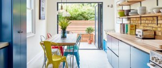 Blue kitchen with a door to the patio of a summer cottage