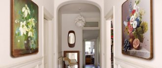 Oil paintings on the wall of a narrow corridor
